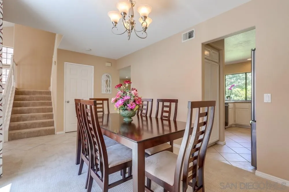 11746 Springside Road San Diego, CA 92128 - Photo 11 of 25 a view of a dining room with furniture and wooden floor