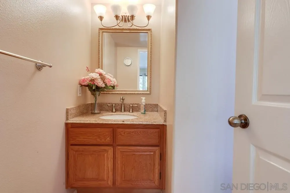 11746 Springside Road San Diego, CA 92128 - Photo 13 of 25 a bathroom with a sink and a mirror