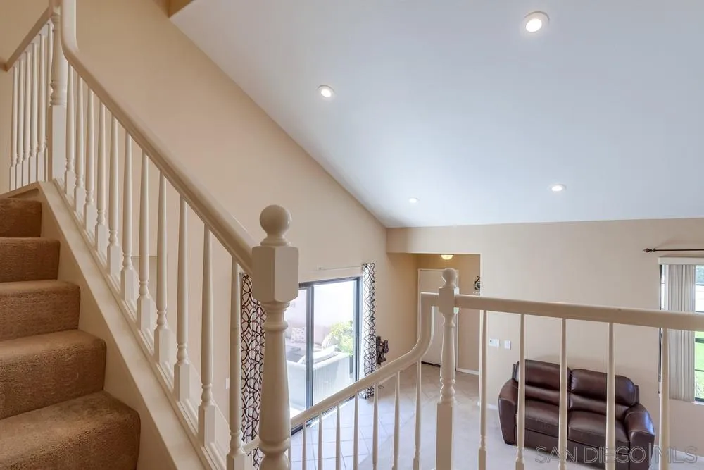 11746 Springside Road San Diego, CA 92128 - Photo 14 of 25 a view of a hallway with wooden floor and staircase