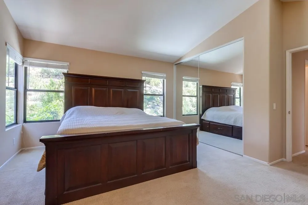 11746 Springside Road San Diego, CA 92128 - Photo 16 of 25 a bedroom with a large bed and a dresser