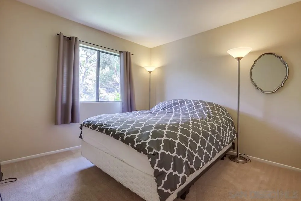 11746 Springside Road San Diego, CA 92128 - Photo 19 of 25 a bed sitting in a bedroom next to a window
