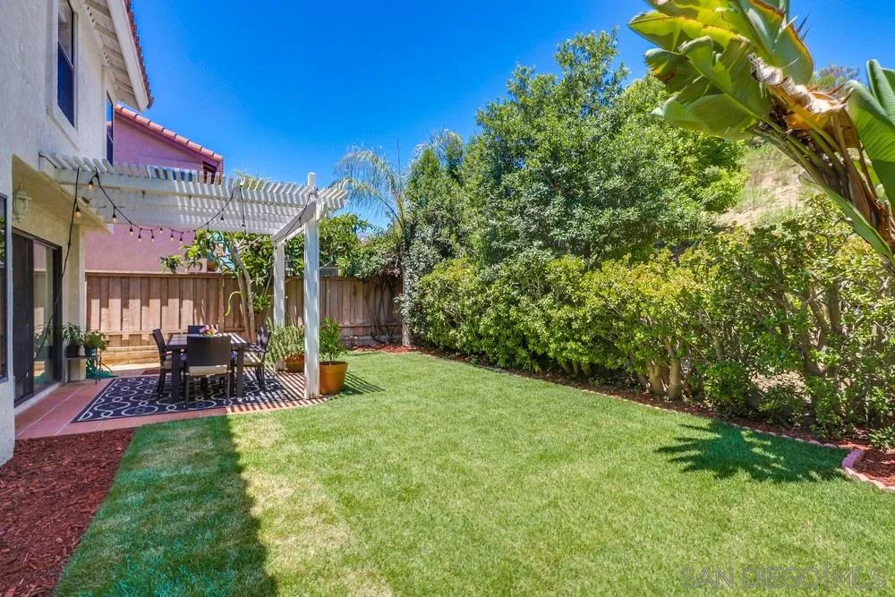 11746 Springside Road San Diego, CA 92128 - Photo 21 of 25 a view of a chairs and tables in the back yard of the house
