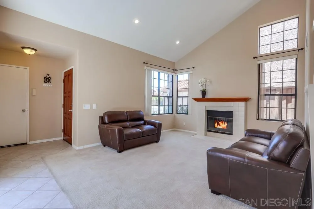 11746 Springside Road San Diego, CA 92128 - Photo 3 of 25 a living room with furniture a flat screen tv and a fireplace