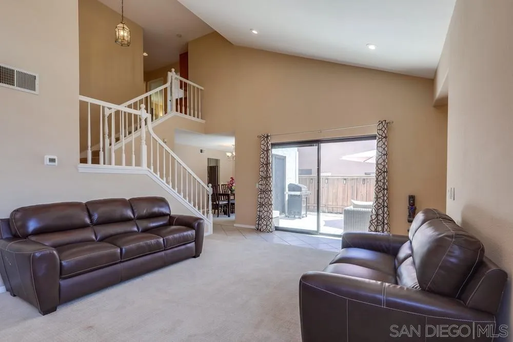 11746 Springside Road San Diego, CA 92128 - Photo 4 of 25 a living room with furniture ceiling fan and a rug