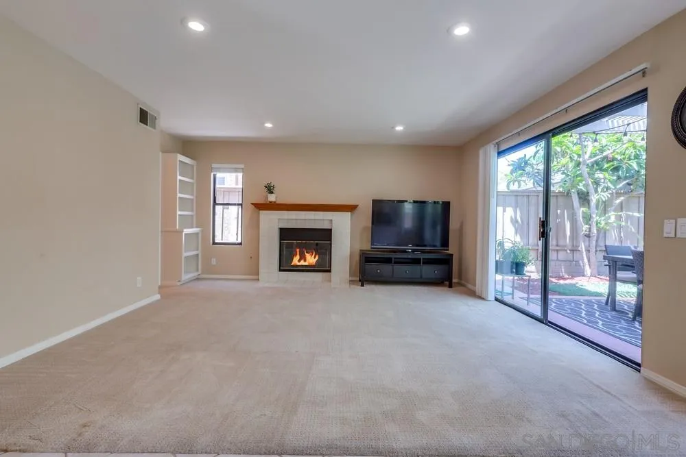 11746 Springside Road San Diego, CA 92128 - Photo 6 of 25 a living room with furniture a flat screen tv and a fireplace