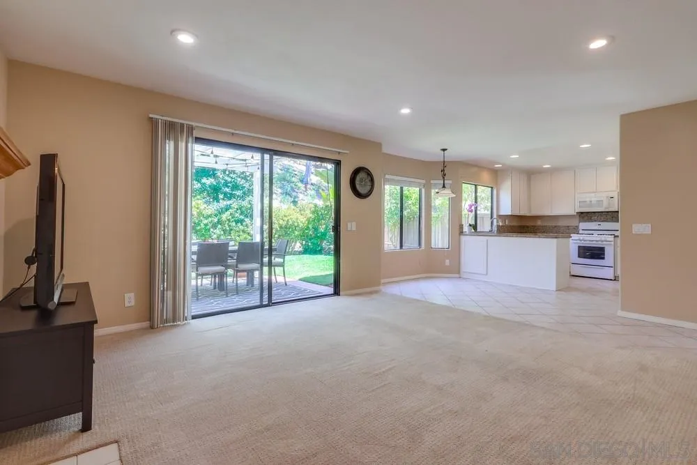 11746 Springside Road San Diego, CA 92128 - Photo 7 of 25 a view of an empty room with a fireplace and a large window