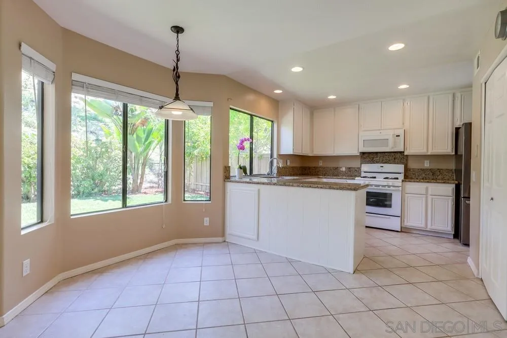 11746 Springside Road San Diego, CA 92128 - Photo 8 of 25 a kitchen with a stove a sink and a refrigerator