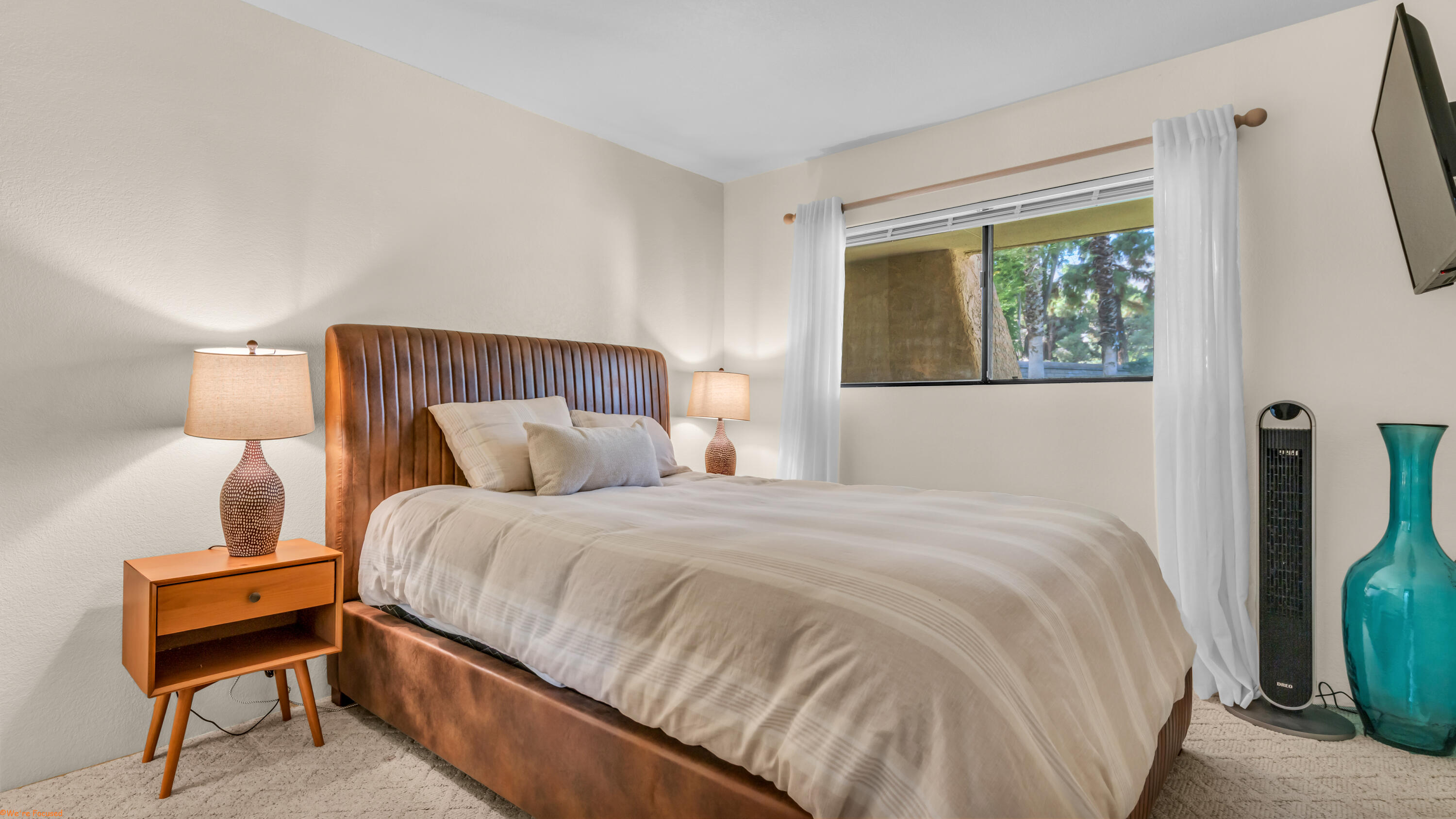 2800 Los Felices Circle North, Unit 107 Palm Springs, CA 92262 - Photo 14 of 18 a bedroom with a bed and a chair