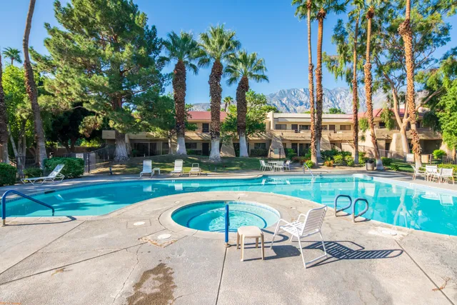 a swimming pool with outdoor seating and yard