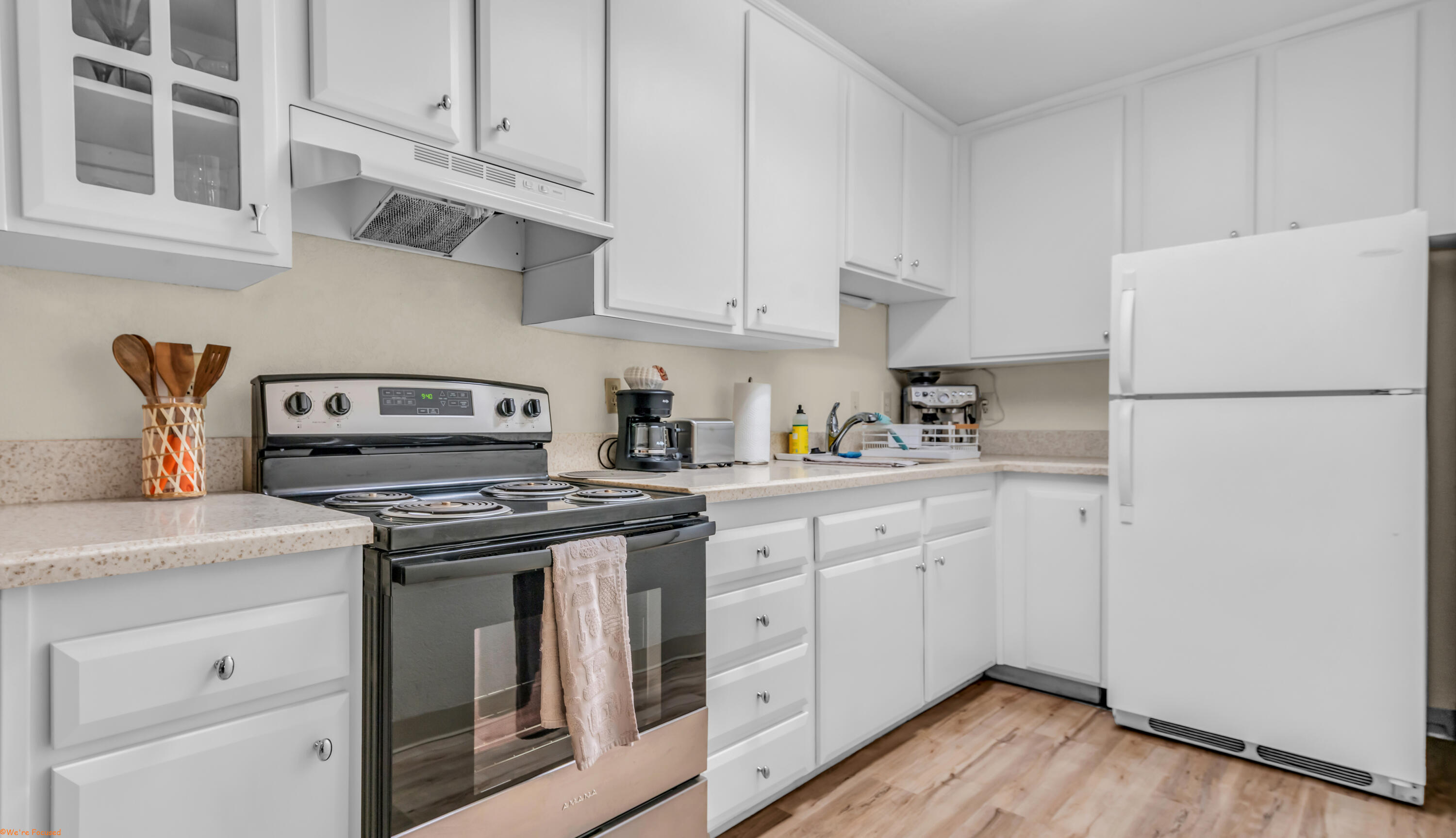 2800 Los Felices Circle North, Unit 107 Palm Springs, CA 92262 - Photo 7 of 18 a kitchen with cabinets appliances a sink and a counter