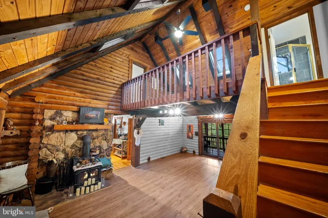 a view of a patio with table and chairs with wooden floor and stairs