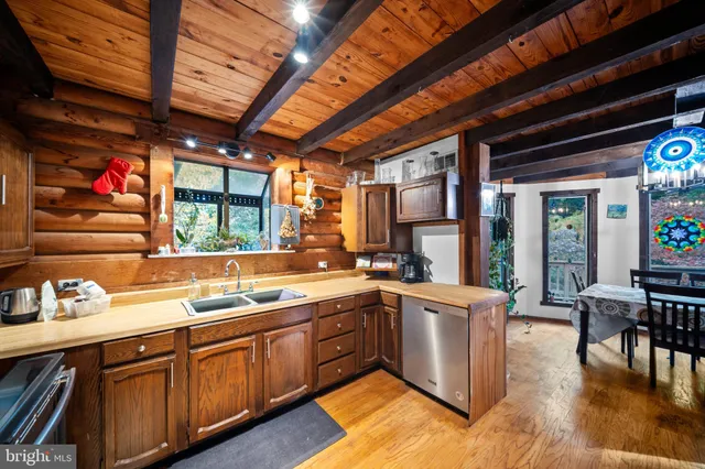 a aerial view of a house with a yard and trees