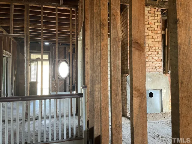 a view of an empty room with a fireplace