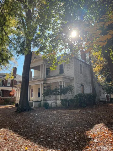 a view of a house with a tree