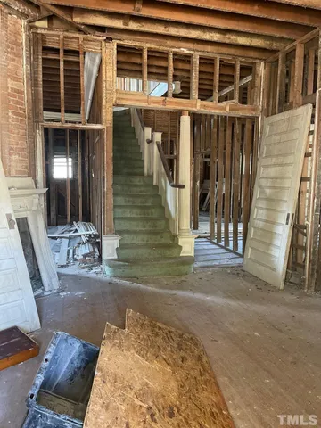 a view of a house with wooden fence