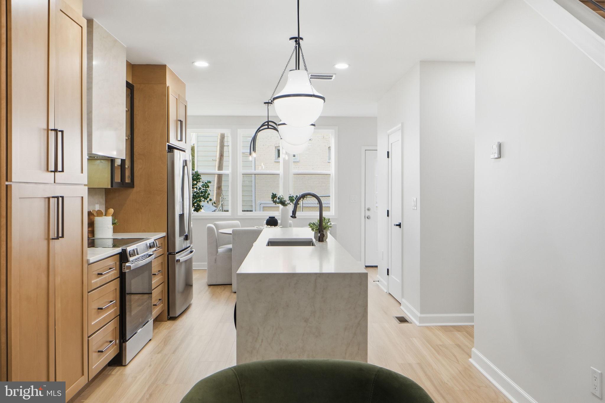 1412 Trinidad Avenue Northeast Washington, DC 20002 - Photo 11 of 47 a living room with stainless steel appliances kitchen island granite countertop furniture and a kitchen view