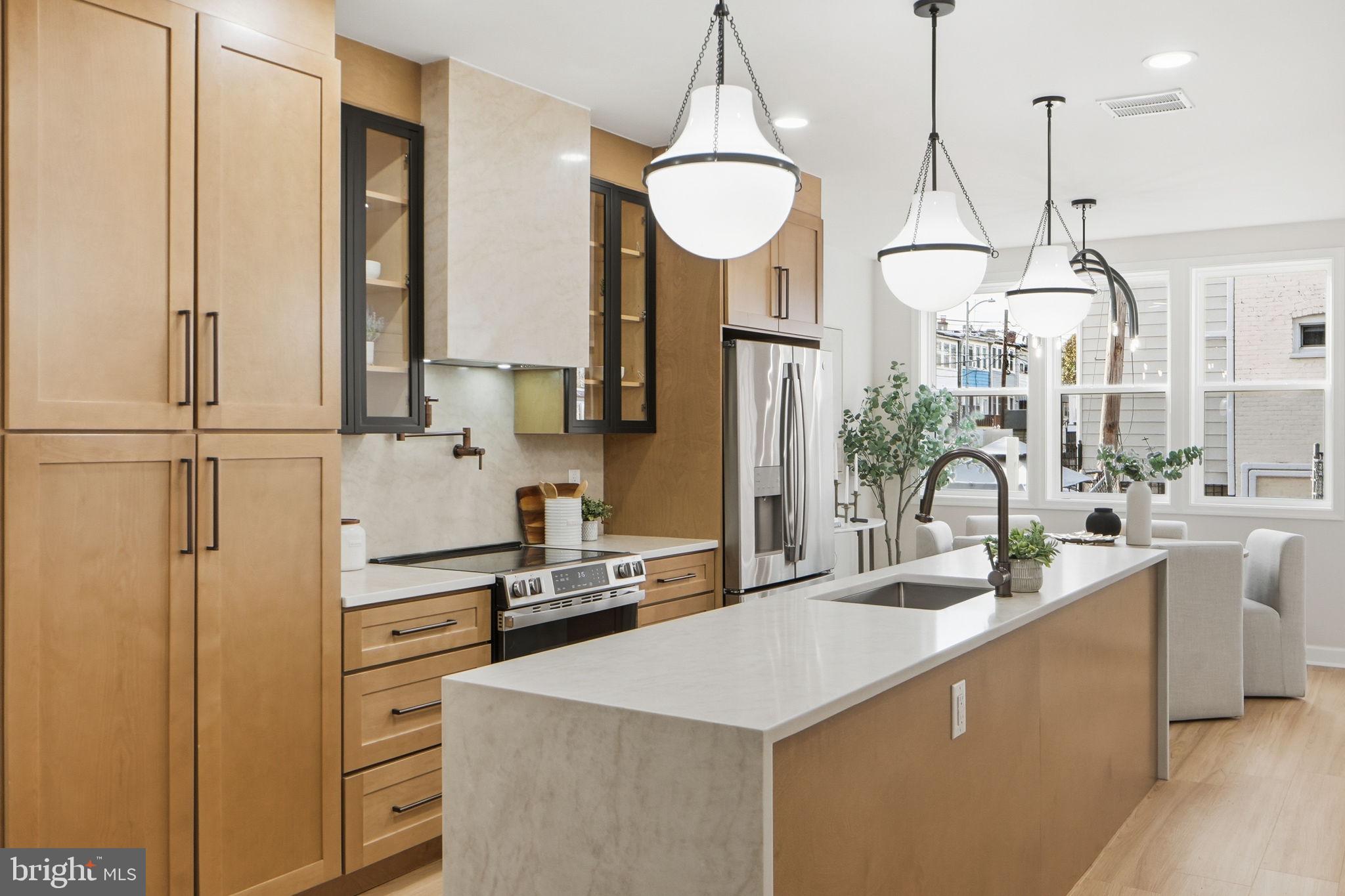 1412 Trinidad Avenue Northeast Washington, DC 20002 - Photo 13 of 47 a kitchen with stainless steel appliances a counter space a sink and cabinets