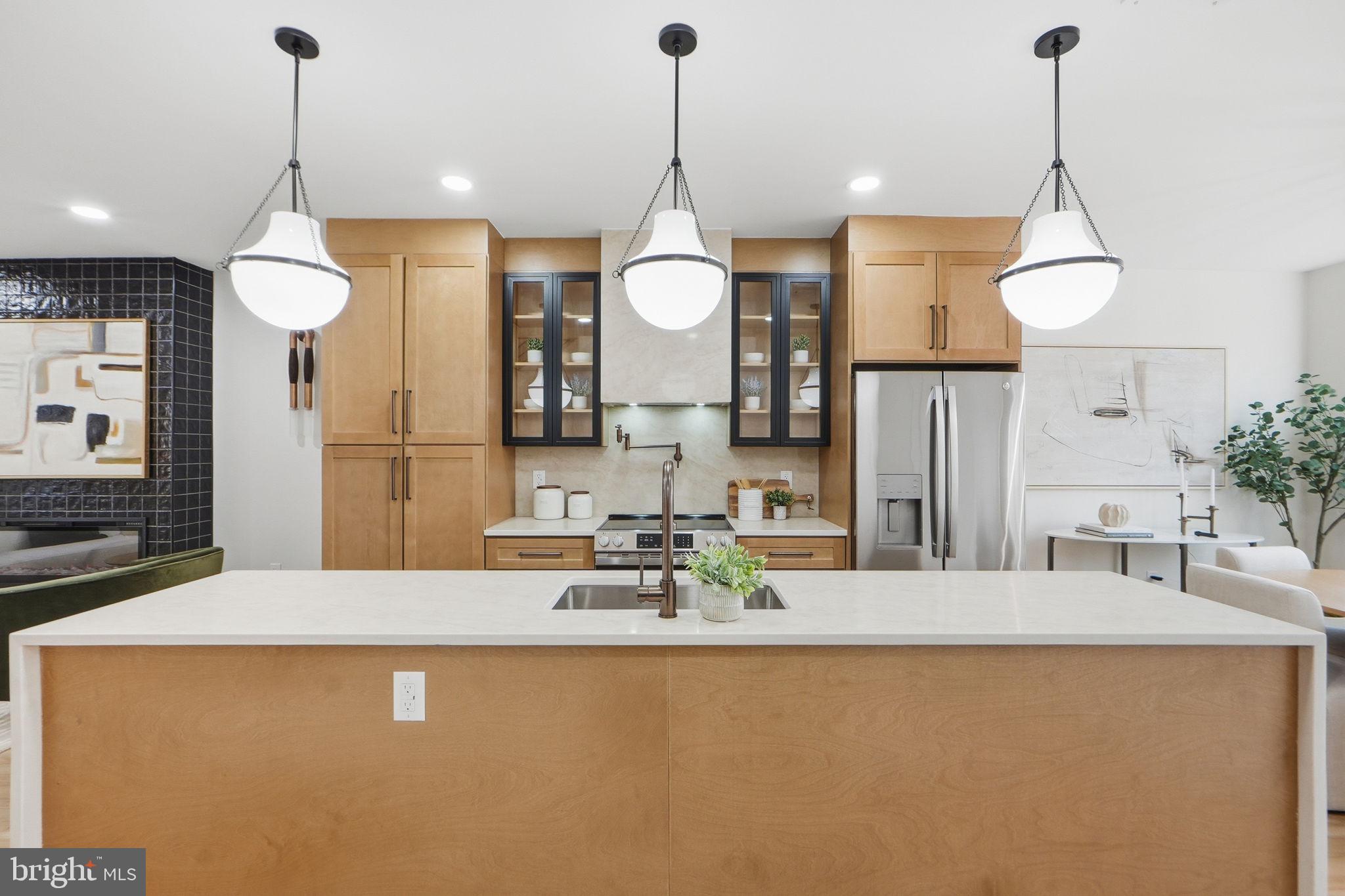 1412 Trinidad Avenue Northeast Washington, DC 20002 - Photo 14 of 47 a kitchen with a refrigerator a sink and a wooden floor
