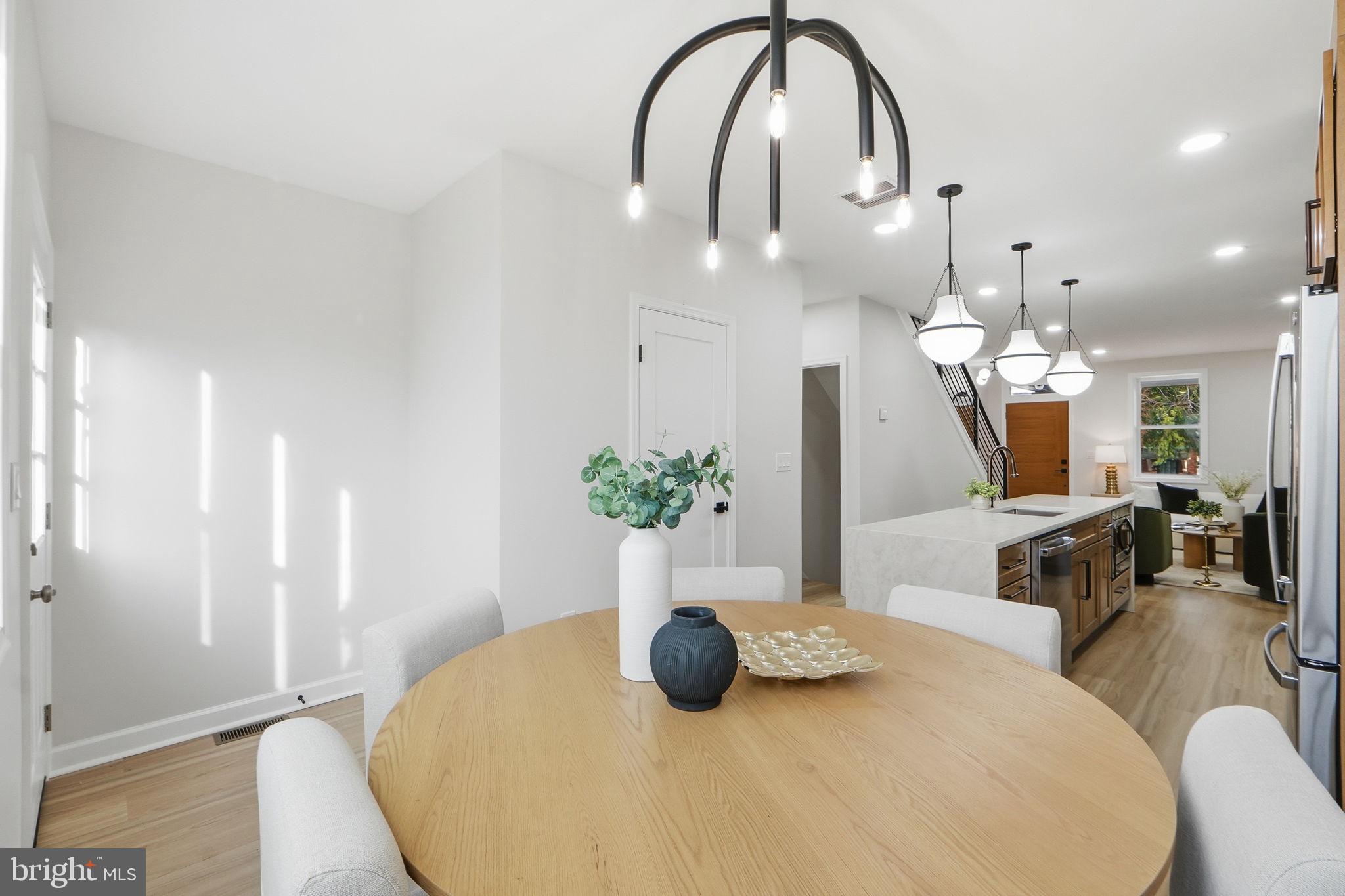 1412 Trinidad Avenue Northeast Washington, DC 20002 - Photo 21 of 47 a bedroom with a bed a potted plant and a large mirror