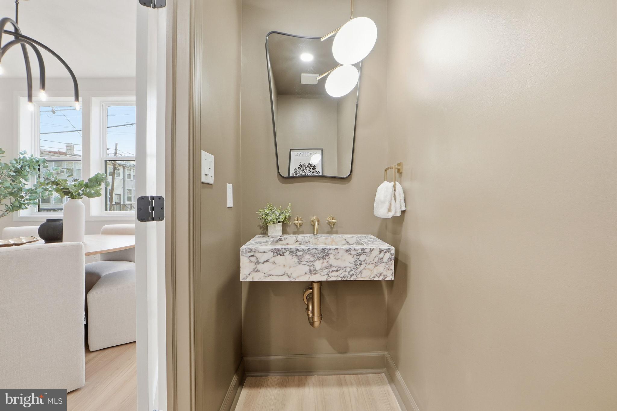 1412 Trinidad Avenue Northeast Washington, DC 20002 - Photo 22 of 47 a bathroom with a sink a light fixture and a mirror