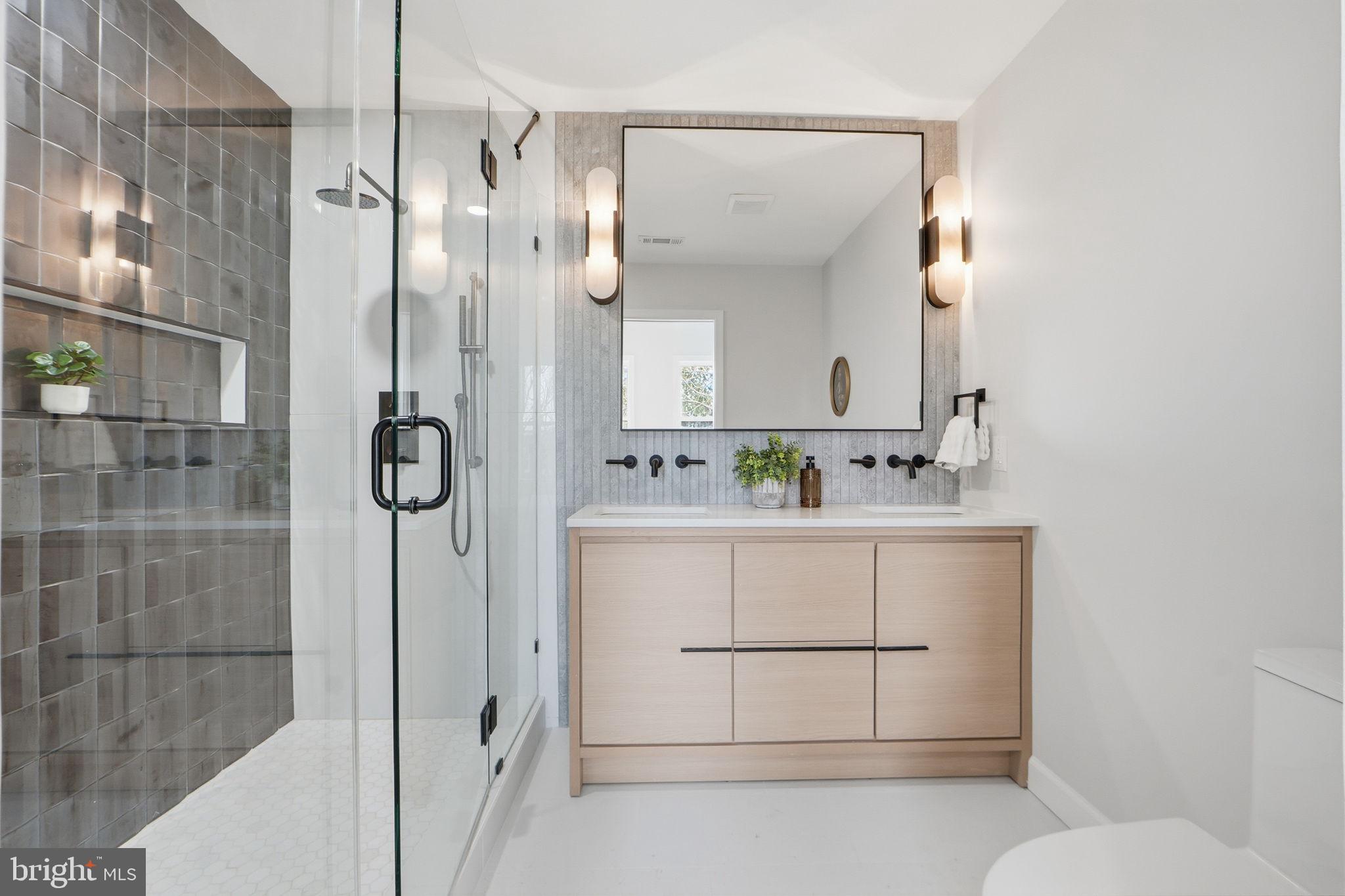 1412 Trinidad Avenue Northeast Washington, DC 20002 - Photo 27 of 47 a bathroom with a shower sink and mirror