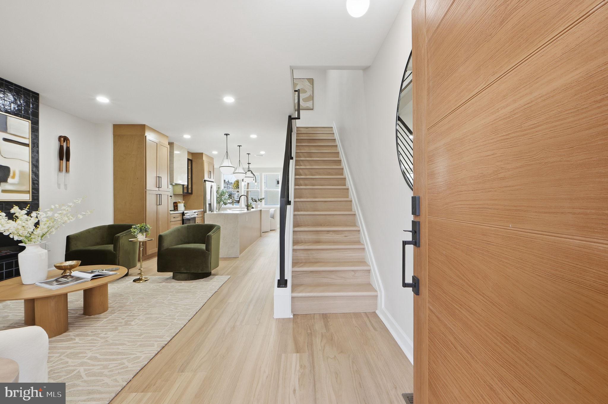 1412 Trinidad Avenue Northeast Washington, DC 20002 - Photo 3 of 47 a living room with couches and kitchen view with wooden floor
