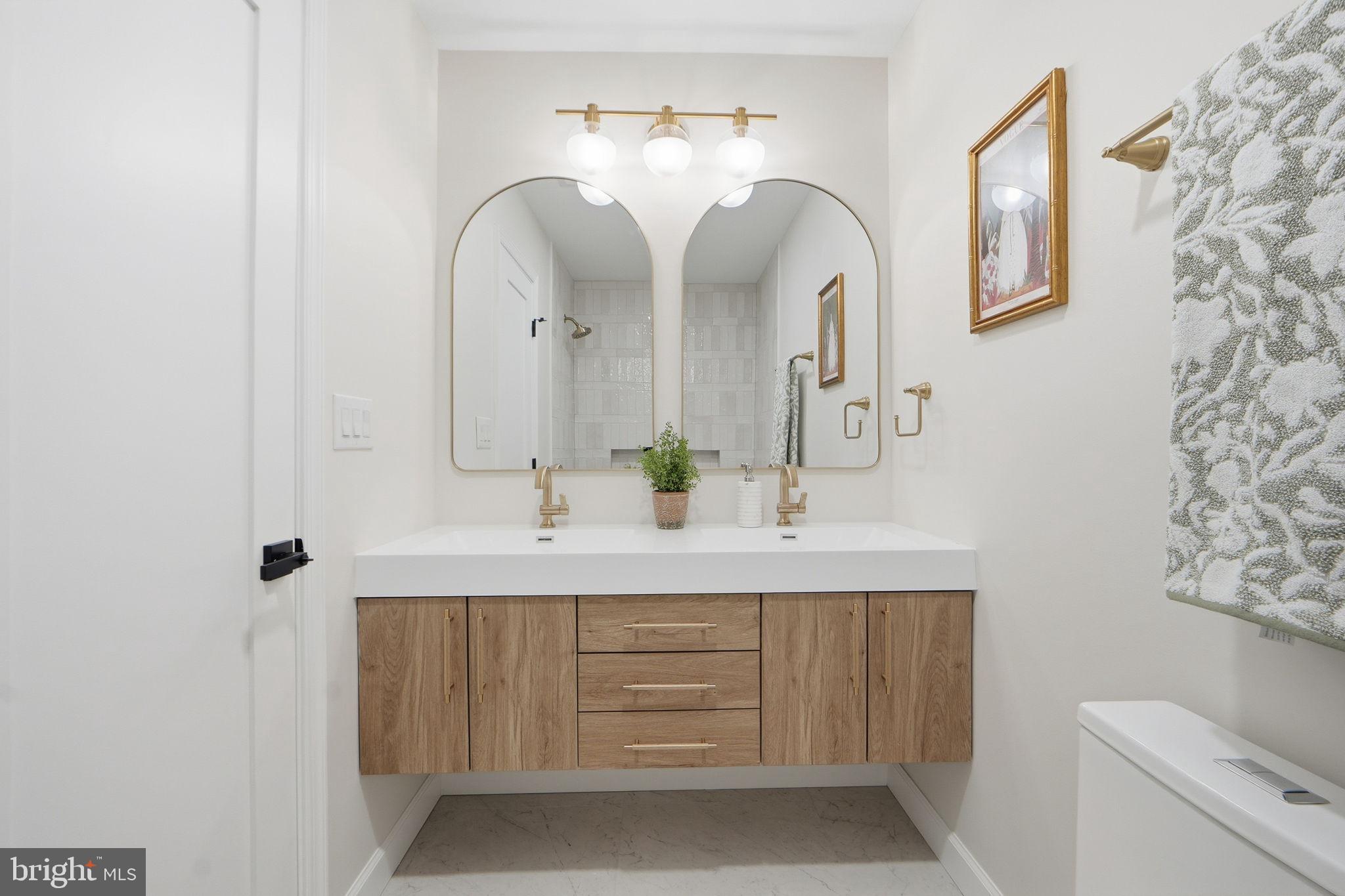 1412 Trinidad Avenue Northeast Washington, DC 20002 - Photo 36 of 47 a bathroom with a double vanity sink and a mirror