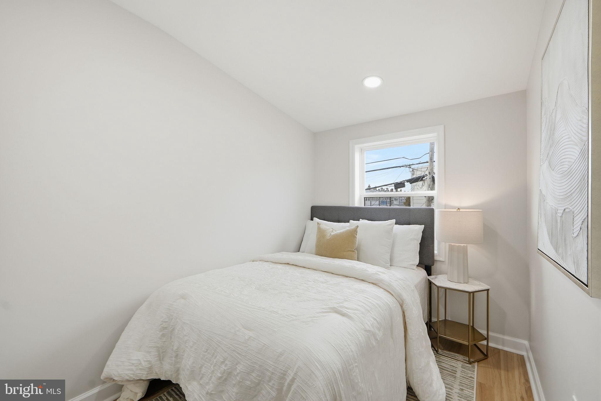 1412 Trinidad Avenue Northeast Washington, DC 20002 - Photo 38 of 47 a bedroom with a bed and a lamp