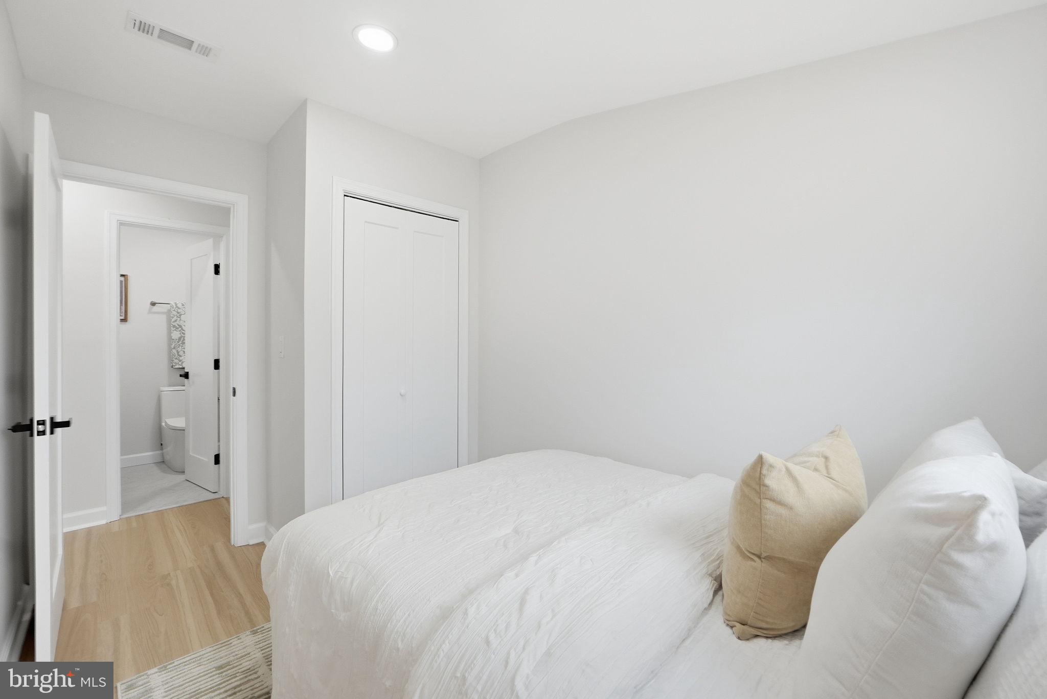 1412 Trinidad Avenue Northeast Washington, DC 20002 - Photo 39 of 47 a bedroom with a bed and a couch