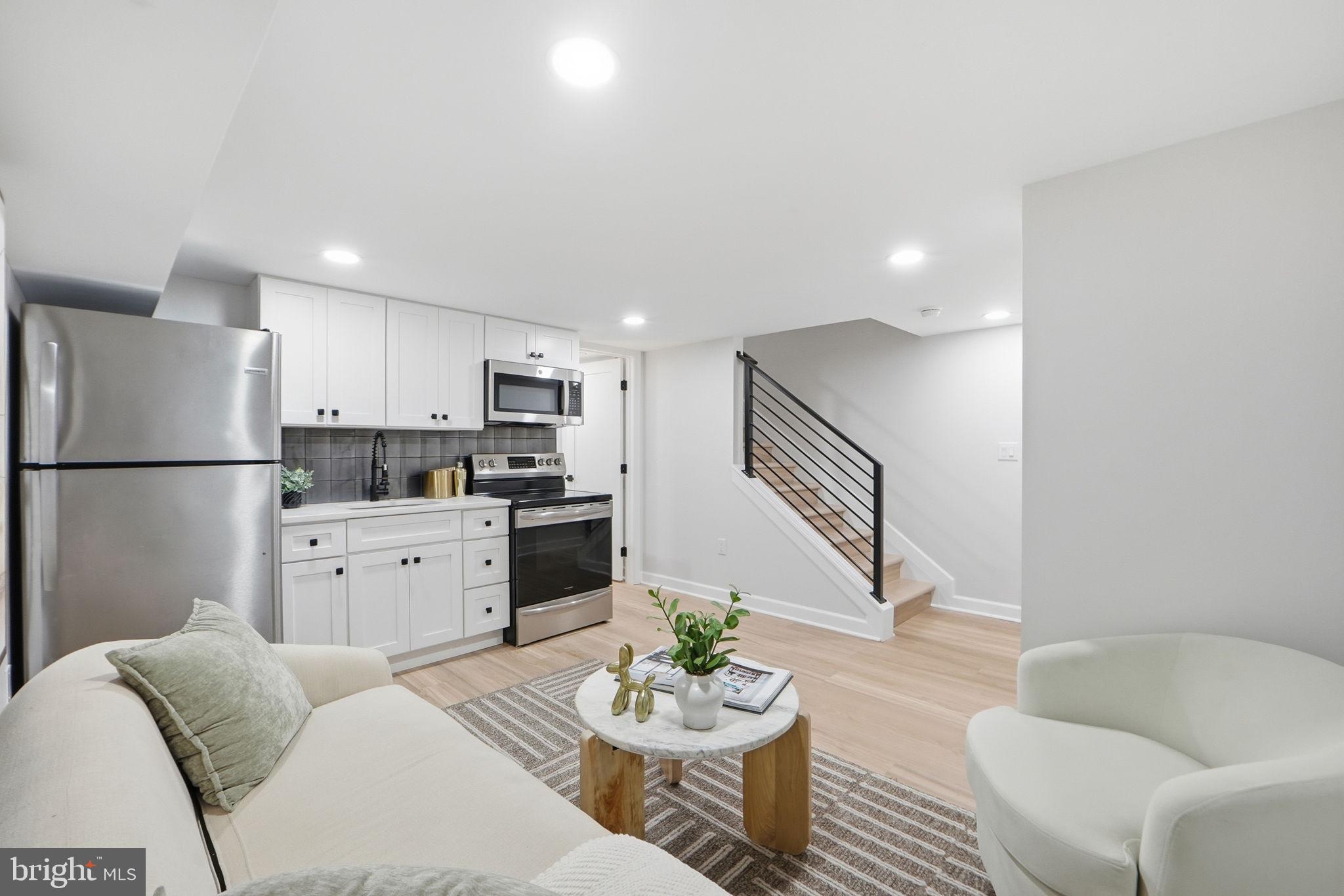 1412 Trinidad Avenue Northeast Washington, DC 20002 - Photo 41 of 47 a living room with furniture kitchen and a refrigerator