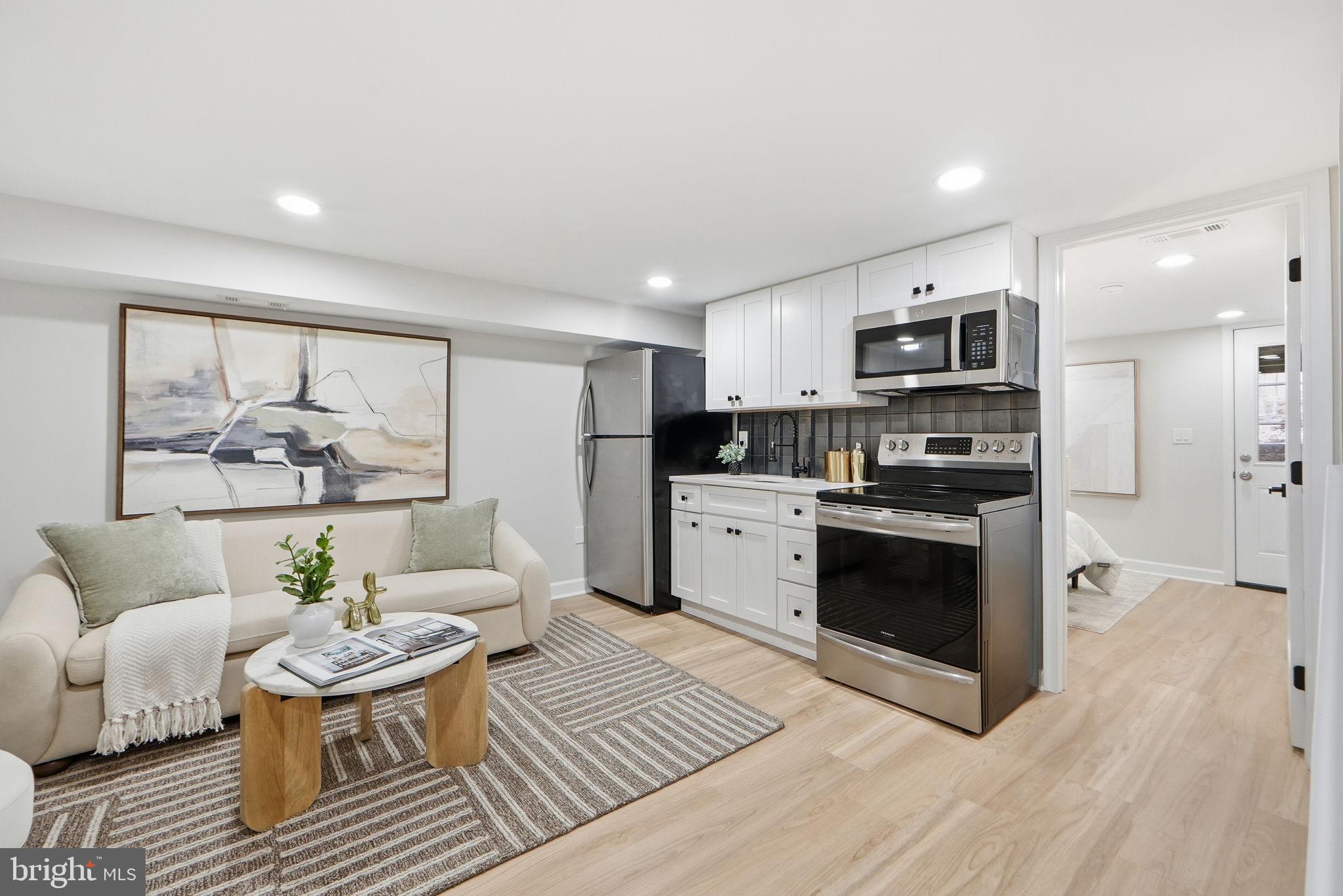 1412 Trinidad Avenue Northeast Washington, DC 20002 - Photo 42 of 47 a living room with stainless steel appliances kitchen island granite countertop a couch and wooden floor