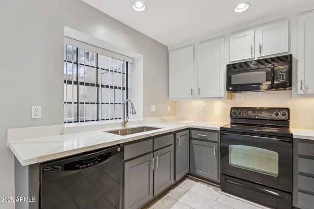 a kitchen with a sink stove and microwave