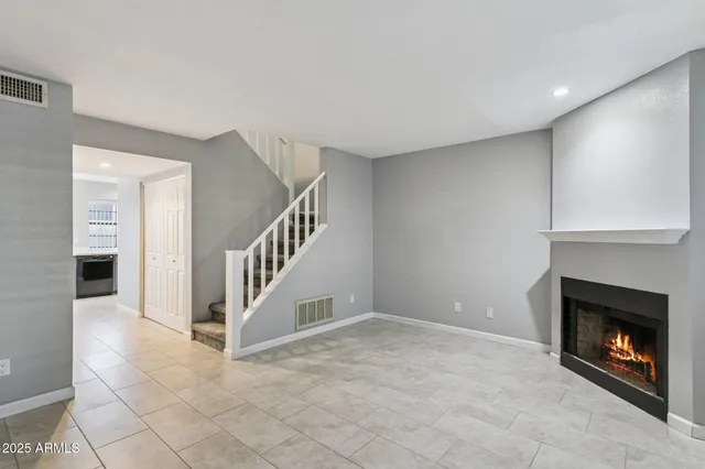 a view of an empty room and fire place