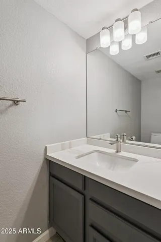 a bathroom with a sink a vanity and a mirror