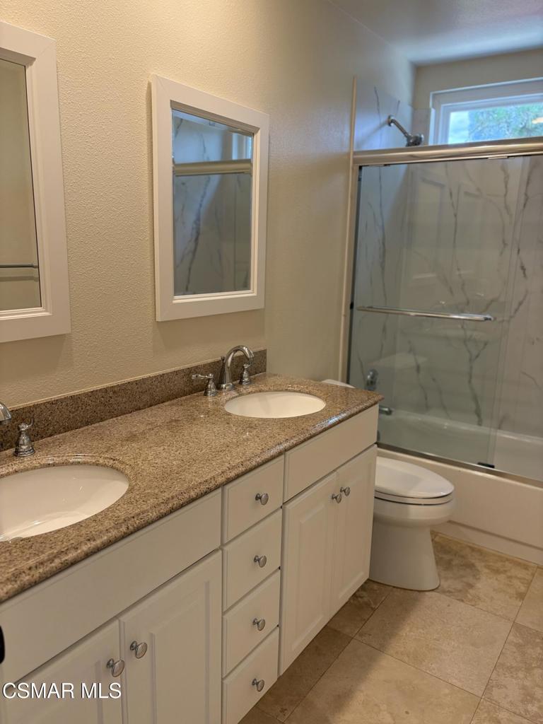 12015 River Grove Court Moorpark, CA 93021 - Photo 18 of 33 a bathroom with a granite countertop sink a toilet and a bathtub