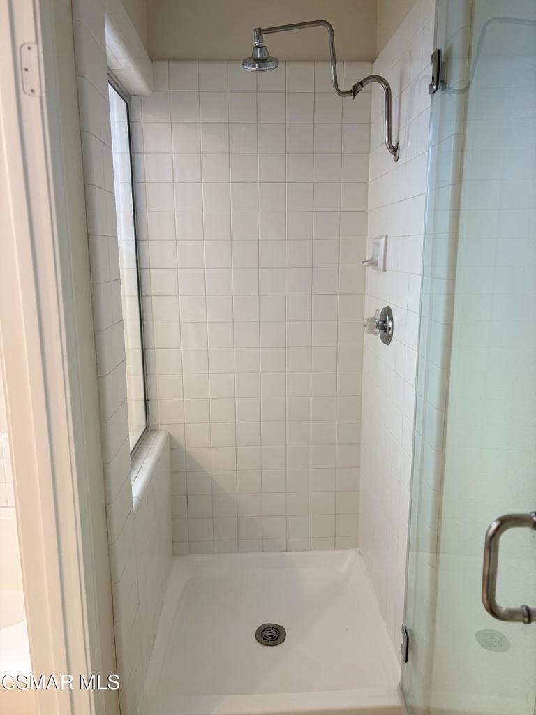 12015 River Grove Court Moorpark, CA 93021 - Photo 25 of 33 a bathroom with a glass shower door