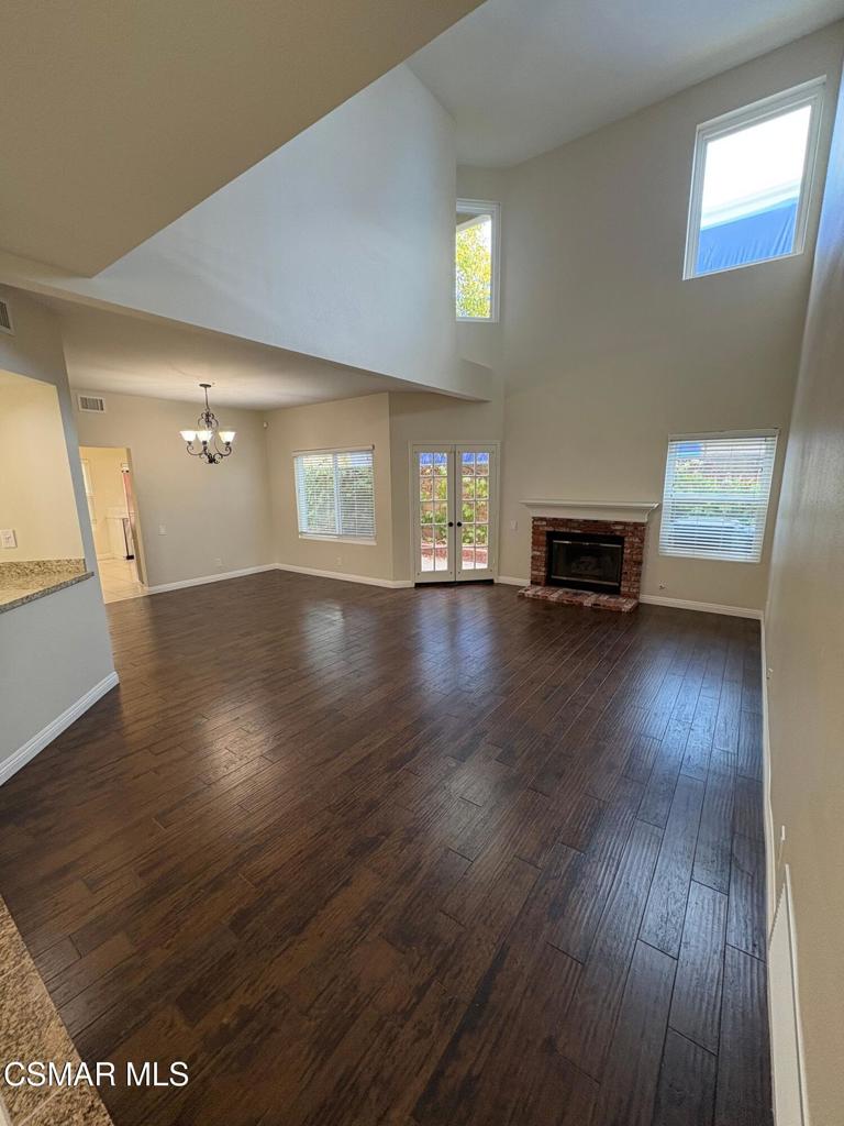 12015 River Grove Court Moorpark, CA 93021 - Photo 5 of 33 a view of empty room with wooden floor and fireplace