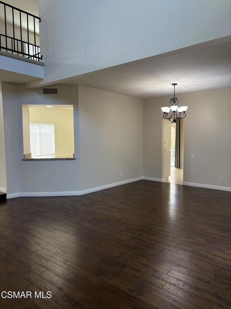 12015 River Grove Court Moorpark, CA 93021 - Photo 7 of 33 an empty room with wooden floor and windows