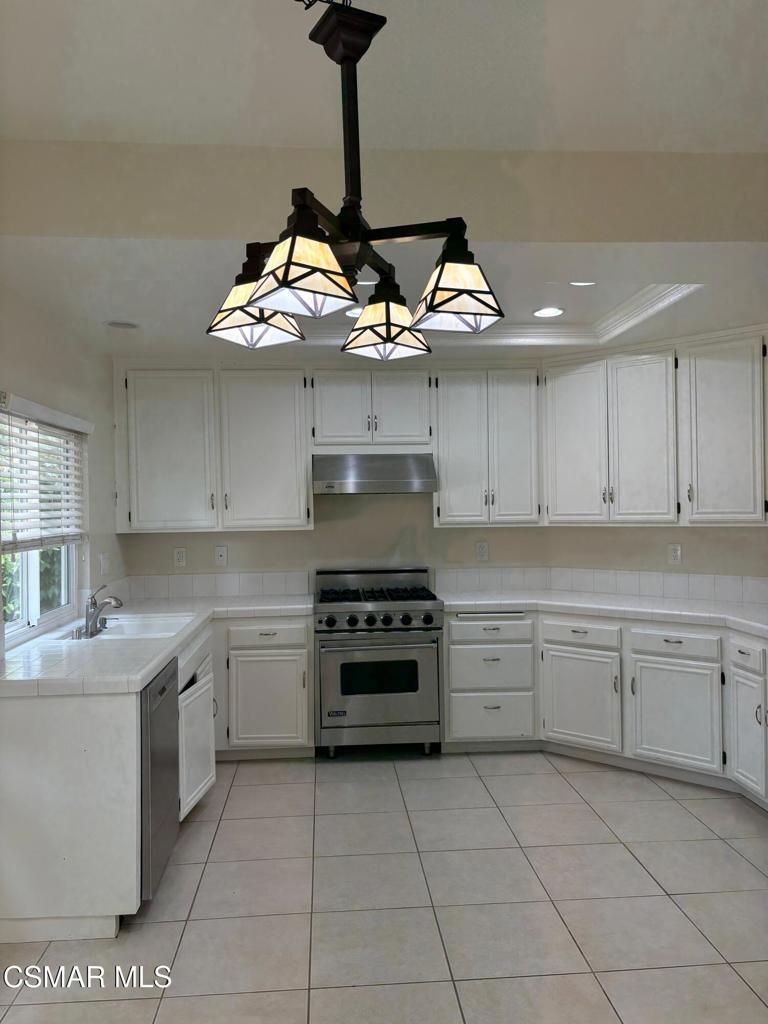 12015 River Grove Court Moorpark, CA 93021 - Photo 10 of 33 a kitchen with stainless steel appliances granite countertop a sink and a stove