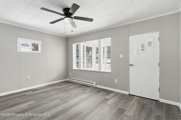 wooden floor in an empty room with a window