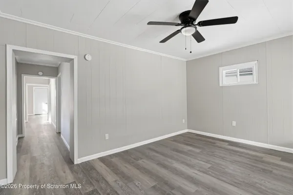a view of room with hardwood floor and ceiling fan