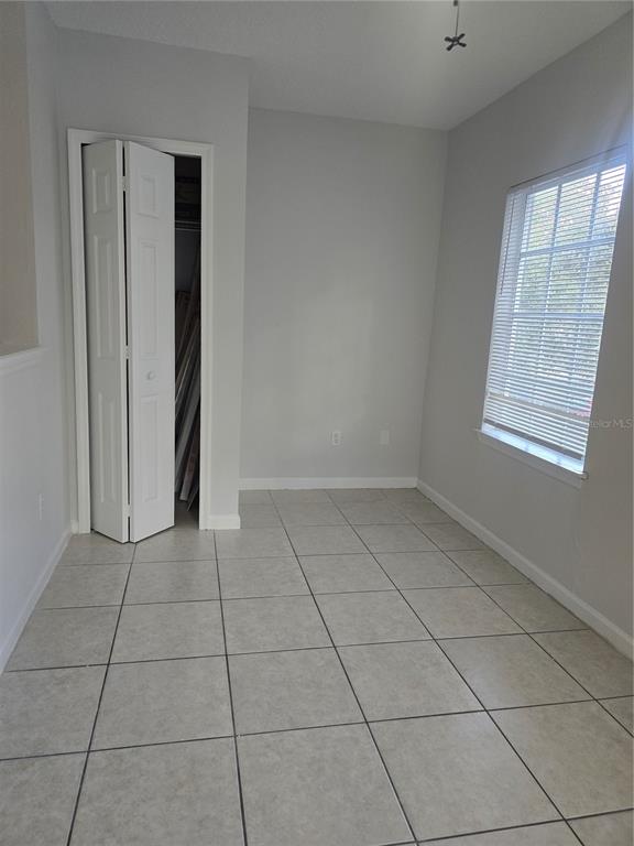 4316 South Kirkman Road, Unit 1608 Orlando, FL 32811 - Photo 3 of 16 an empty room with windows