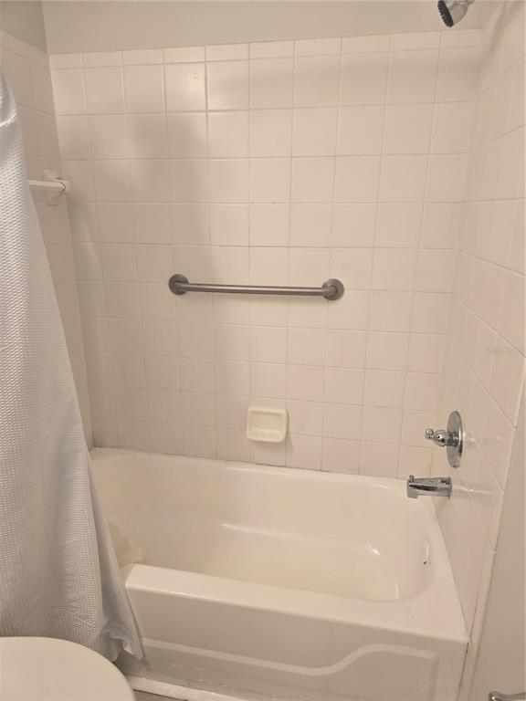 4316 South Kirkman Road, Unit 1608 Orlando, FL 32811 - Photo 7 of 16 a bathroom with a shower and a toilet