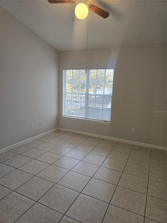4316 South Kirkman Road, Unit 1608 Orlando, FL 32811 - Photo 8 of 16 an empty room with windows and fan