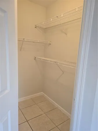 a view of storage and utility room with racks on the wall