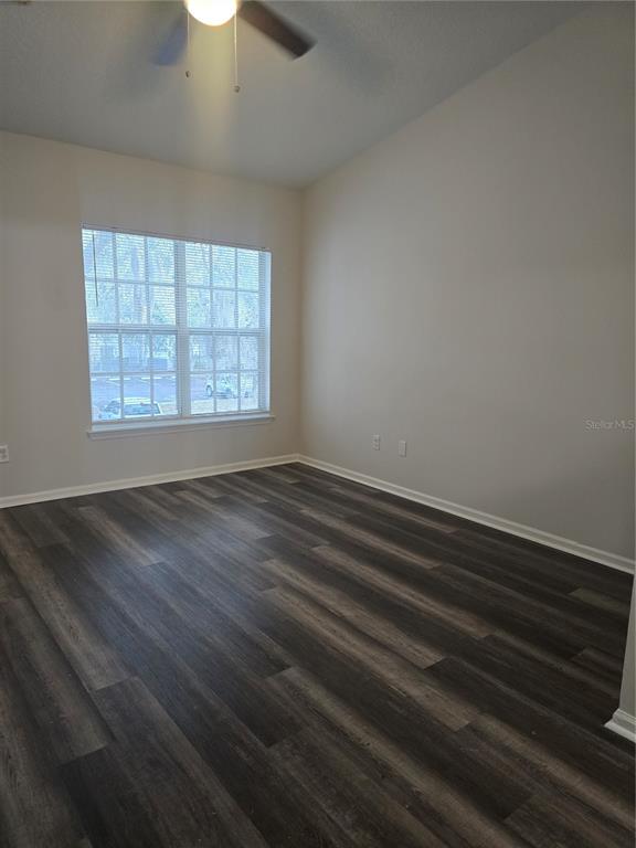 4316 South Kirkman Road, Unit 1608 Orlando, FL 32811 - Photo 10 of 16 an empty room with wooden floor and windows