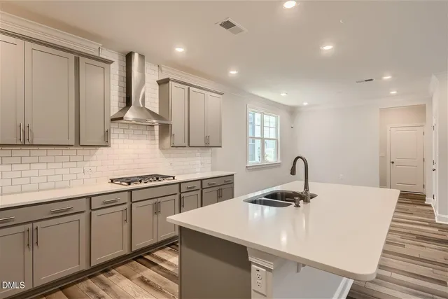 a kitchen with stainless steel appliances a sink stove and cabinets