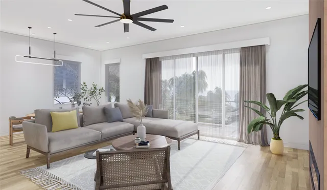 a living room with furniture a chandelier and a potted plant