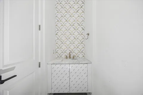 a living room with furniture a chandelier and a potted plant