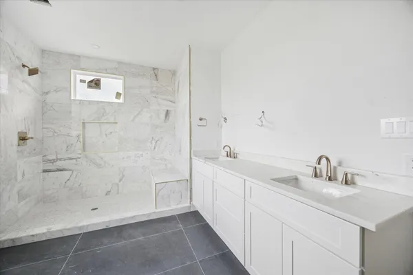 a bathroom with a bathtub and shower